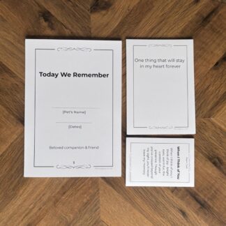 Minimal modern pet loss remembrance ceremony kit with fanned printable cards and pages on an oak table.