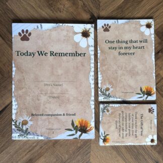 Scrapbook-style pet loss remembrance ceremony kit flat lay showing A4 cover page and matching cards on an oak table.