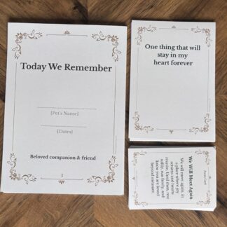 Classic elegant pet remembrance ceremony kit cards on wooden floor, including “Today We Remember” cover, reflection prompt card, and “We Will Meet Again” poem card.